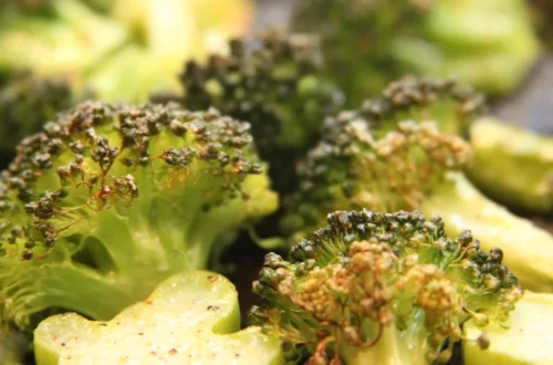 Frozen broccoli florets cooked on a sheet pan with browned edges in a single layer