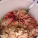 Bowl of creamy cooked oatmeal with visible oat flakes, showing how to cook oatmeal that stays loose